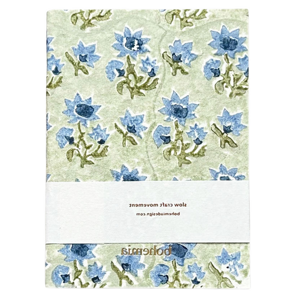 A cotton paper notebook with a vintage blue and green floral design.